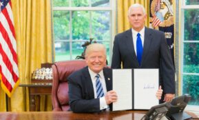 2 men in black suit sitting on red chair