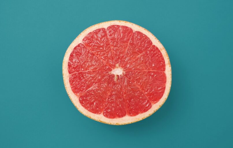 sliced orange fruit on blue background
