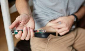 a person holding an insulin injection
