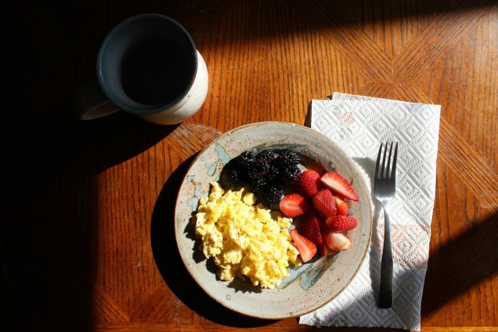 a plate of food sitting on top of a wooden table