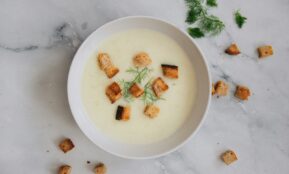 soup with green leaf on white ceramic bowl