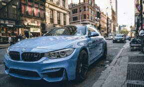 blue BMW coupe parked on the road during daytime