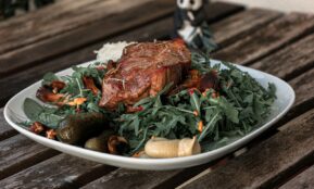 a plate of food on a wooden table