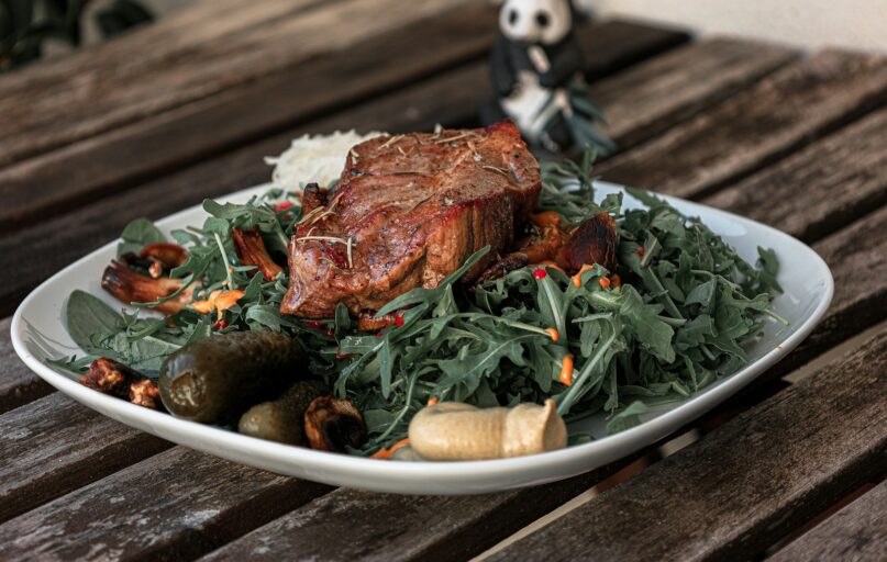 a plate of food on a wooden table