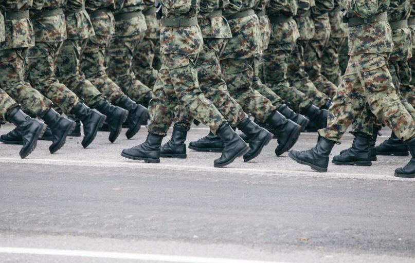 men in green and brown camouflage uniform
