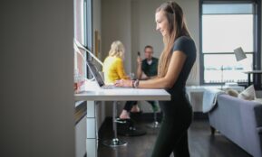 woman in black tank top and black pants sitting on chair