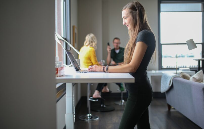 woman in black tank top and black pants sitting on chair