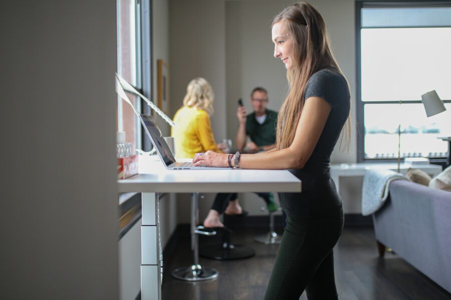 woman in black tank top and black pants sitting on chair