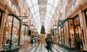 person walking inside building near glass