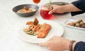 a plate of food and a glass of wine