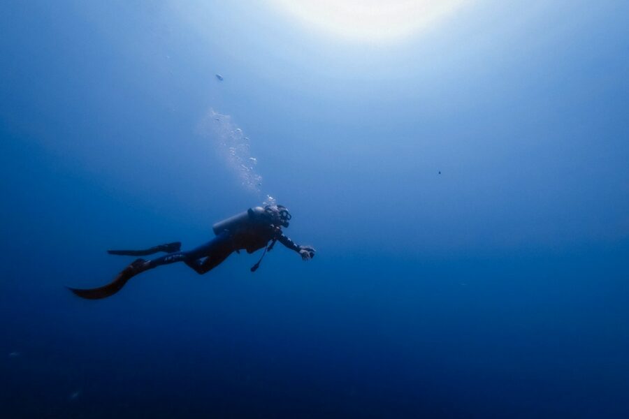 person swimming under water photography