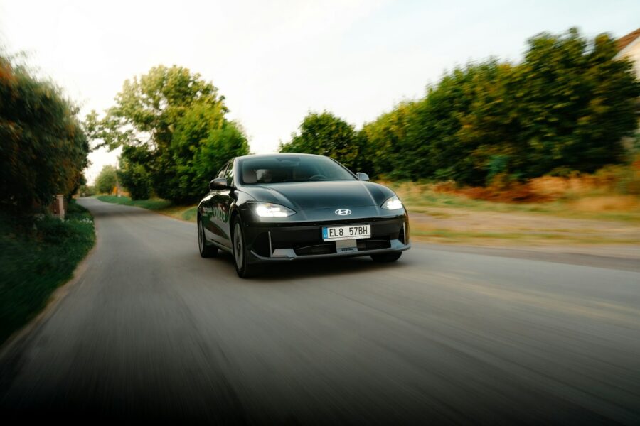 a black sports car driving down a street