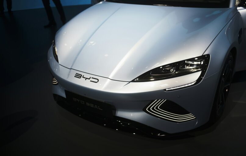 a white sports car is on display at a car show