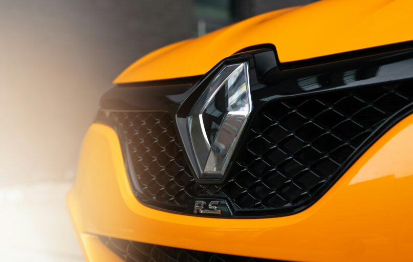 a close up of the front grill of a yellow sports car