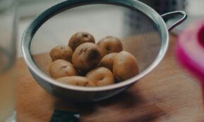 brown round fruits on white ceramic bowl