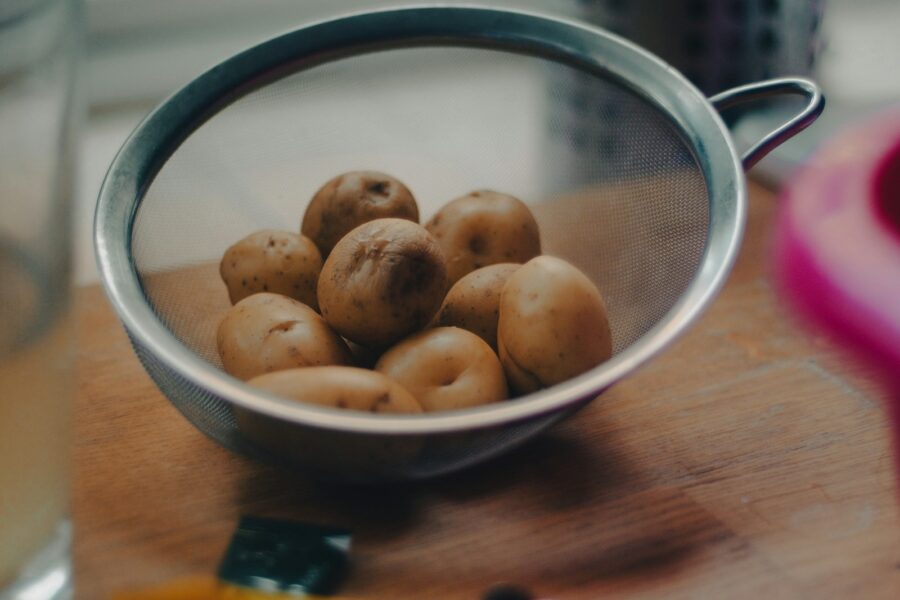brown round fruits on white ceramic bowl
