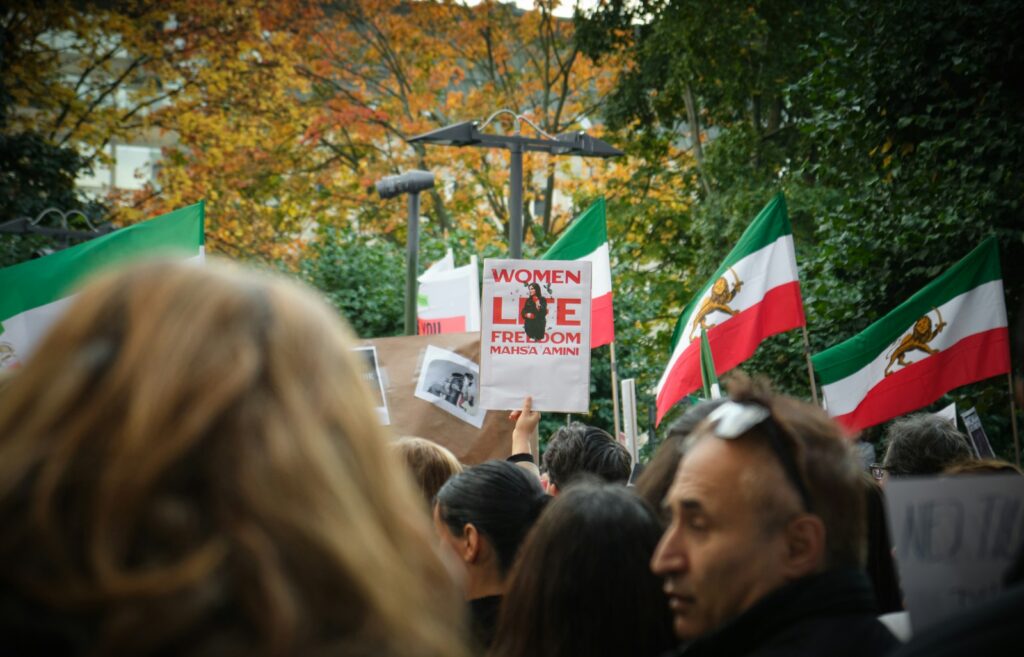 a group of people holding signs and flags
