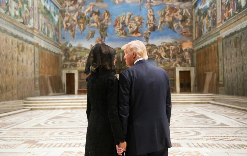 man in black suit standing beside woman in black dress