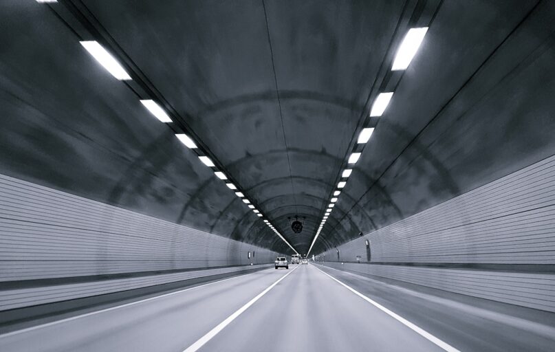time lapse photography of vehicle under tunnel