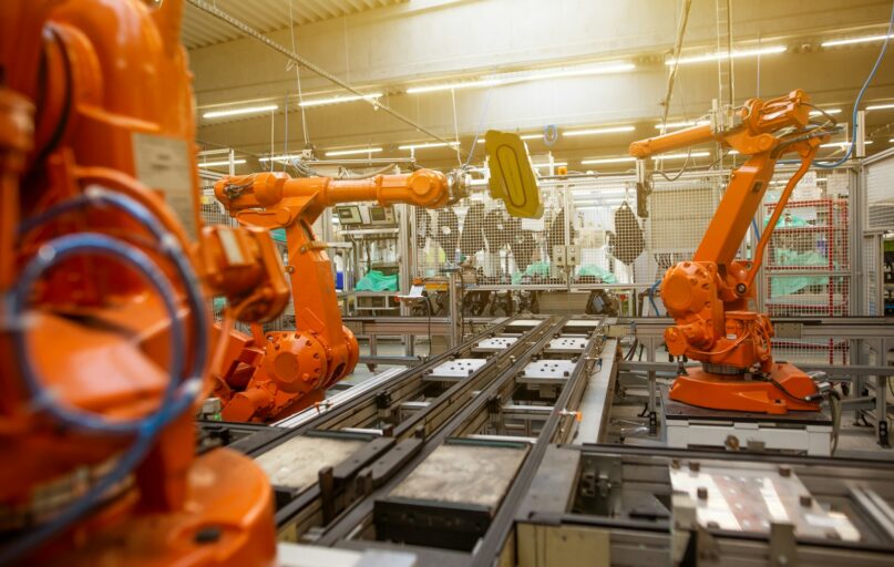 a factory filled with lots of orange machines