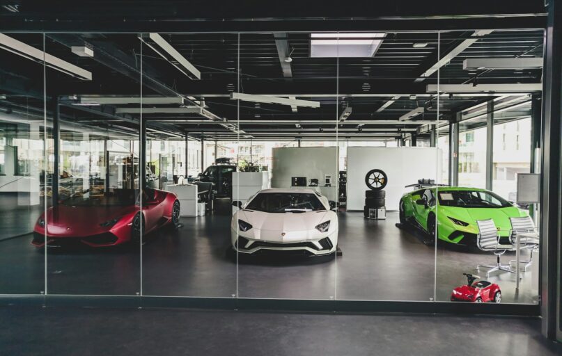 three white, red, and green Lamborghini coupes