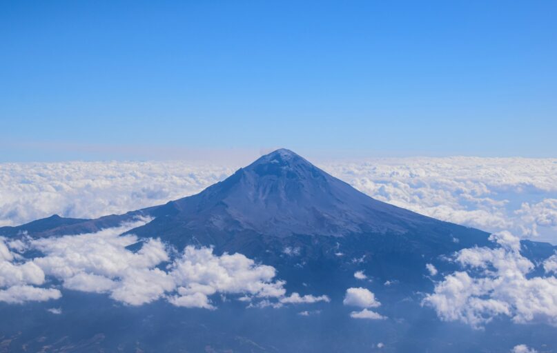 white clouds over snow covered mountain