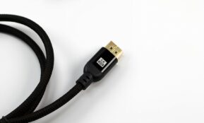 A black braided cable with a gold connector.