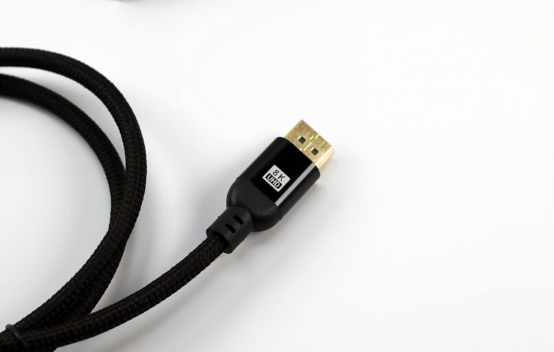 A black braided cable with a gold connector.