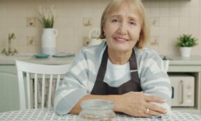 Elderly woman sitting at a kitchen table