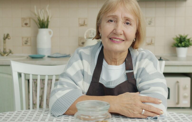 Elderly woman sitting at a kitchen table