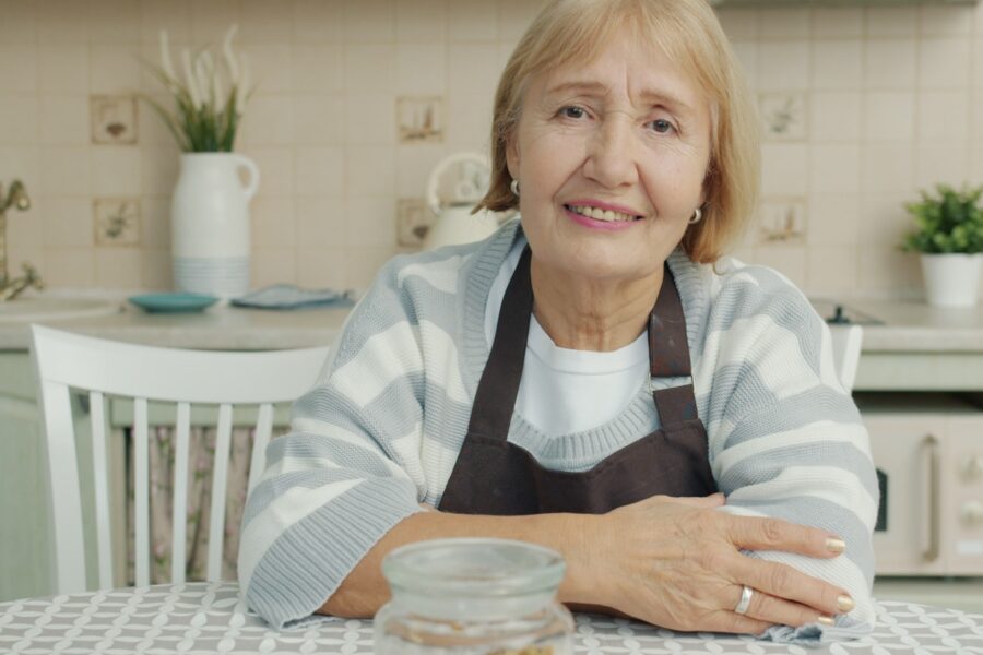 Elderly woman sitting at a kitchen table