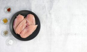 two raw chicken breasts in a black bowl