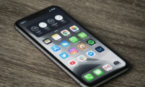 black iphone 5 on brown wooden table