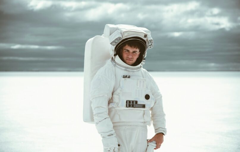 boy in white hoodie standing on snow covered ground during daytime
