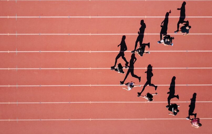group of people running on stadium