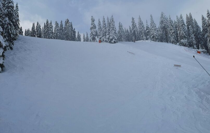 a man riding skis down a snow covered slope