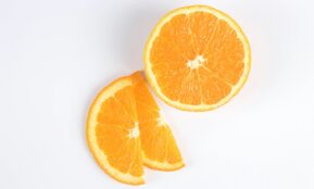 sliced orange fruit on white surface