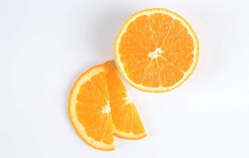 sliced orange fruit on white surface