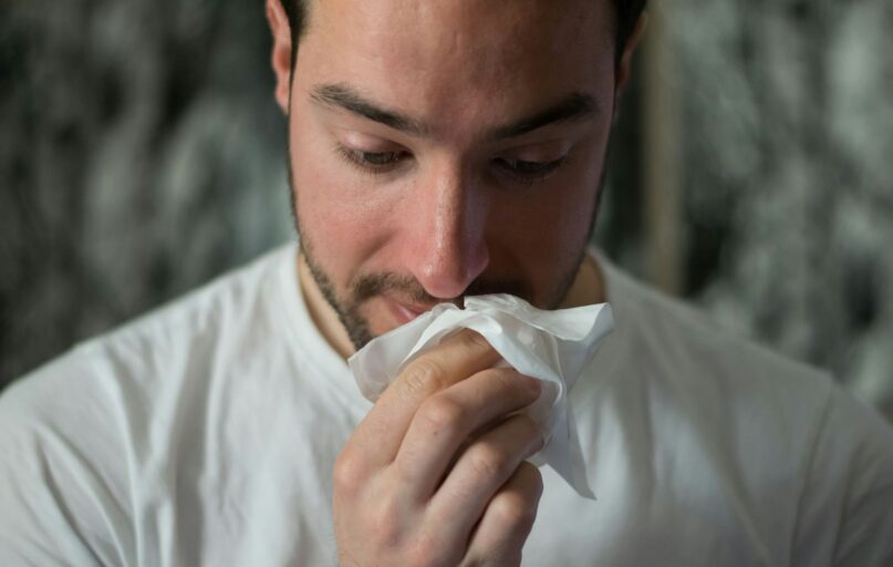 man wiping mouse with tissue paper
