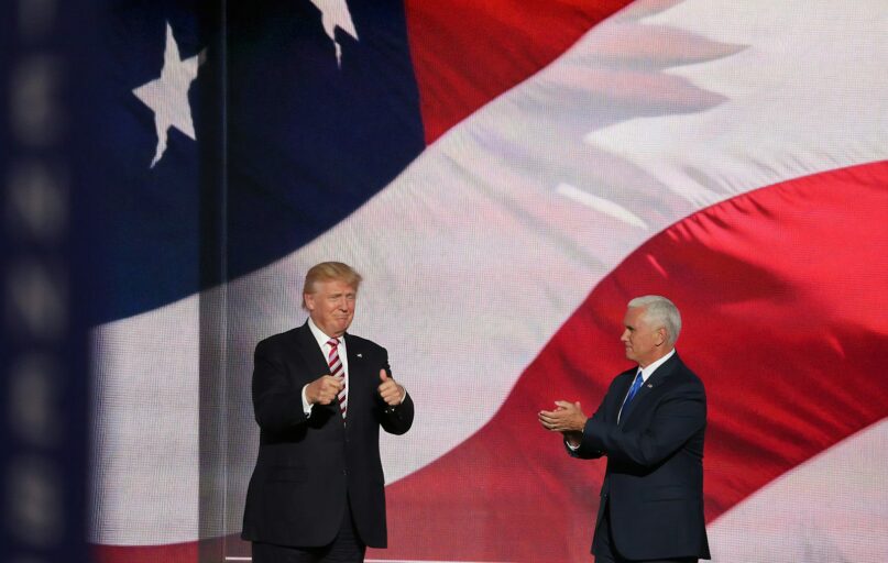 Donald Trump beside man in black suit