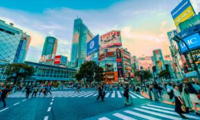 people walking on street under cloudy sky