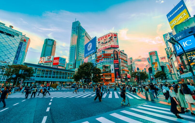 people walking on street under cloudy sky