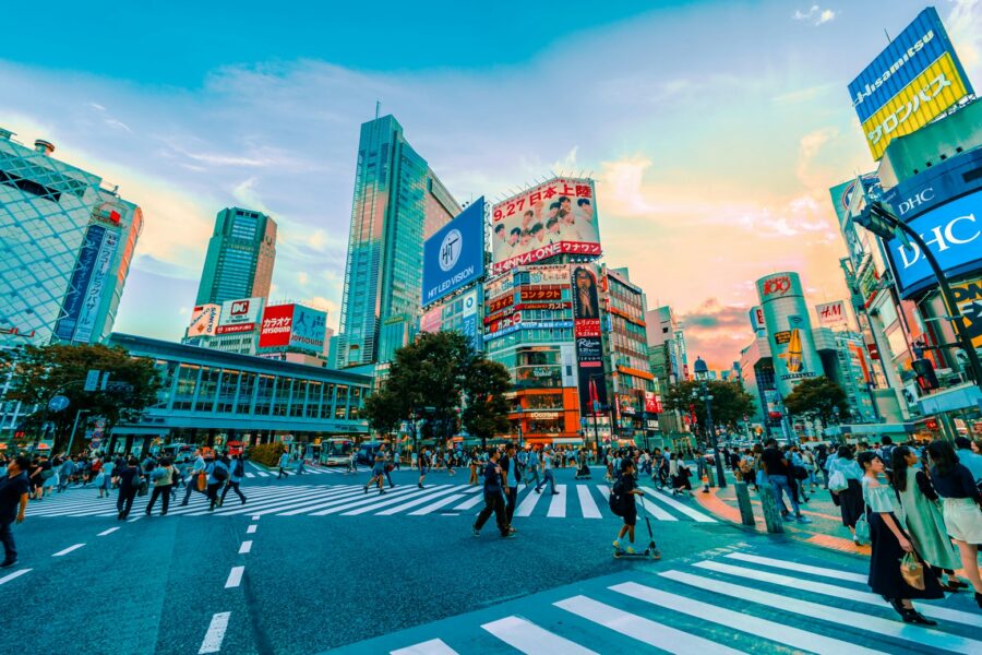 people walking on street under cloudy sky