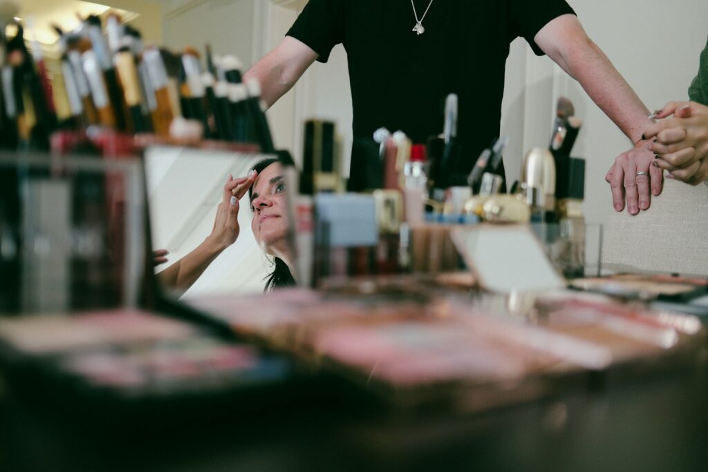 Makeup artist applying makeup to a person.