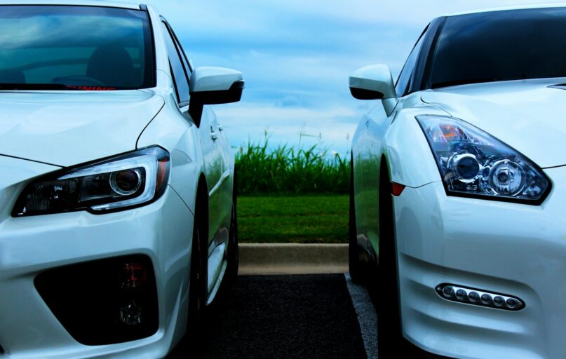 white Nissan GT-R and white Mitsubishi Lancer Evolution 10