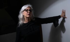 woman in black long sleeve shirt wearing eyeglasses