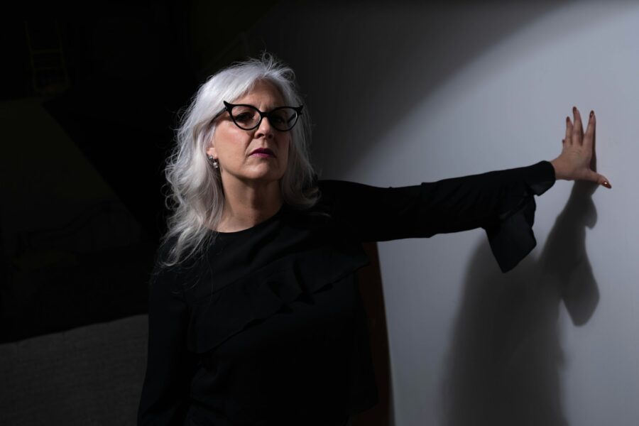 woman in black long sleeve shirt wearing eyeglasses
