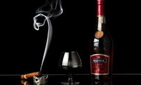 a bottle of wine next to a glass of wine