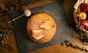 A table topped with a donut covered in icing