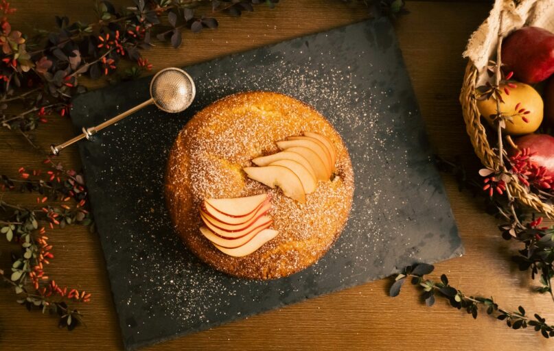 A table topped with a donut covered in icing